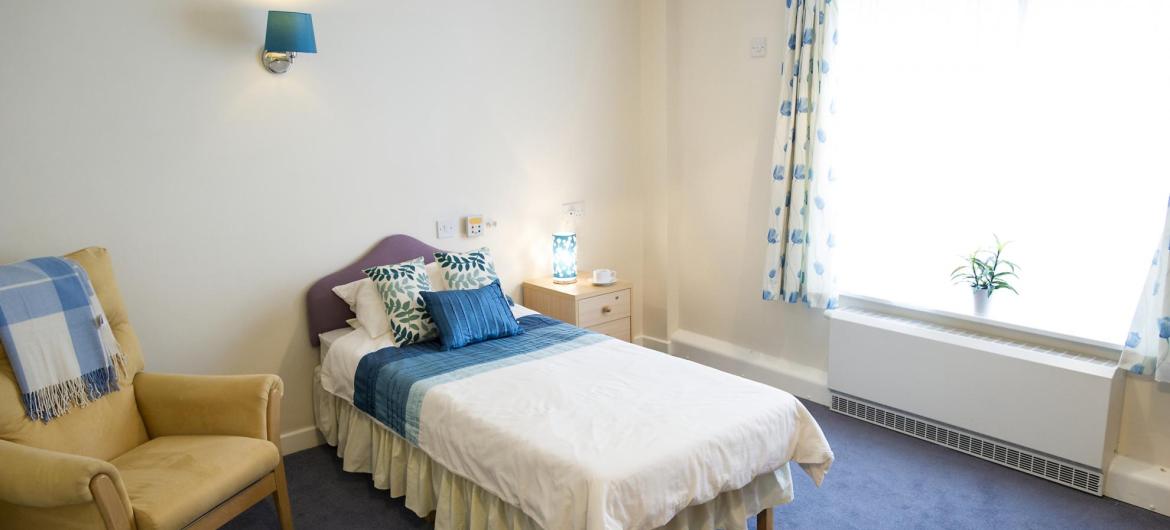 A pretty blue and white bedroom at Time Court Residential and Nursing Home.