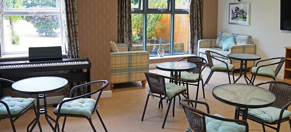 Garden room seating area at Briarscroft Residential Care Home in Birmingham