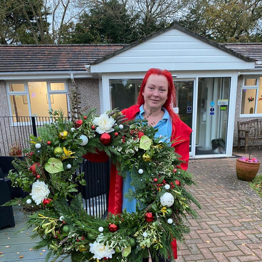Parla holding one of her festive wreaths