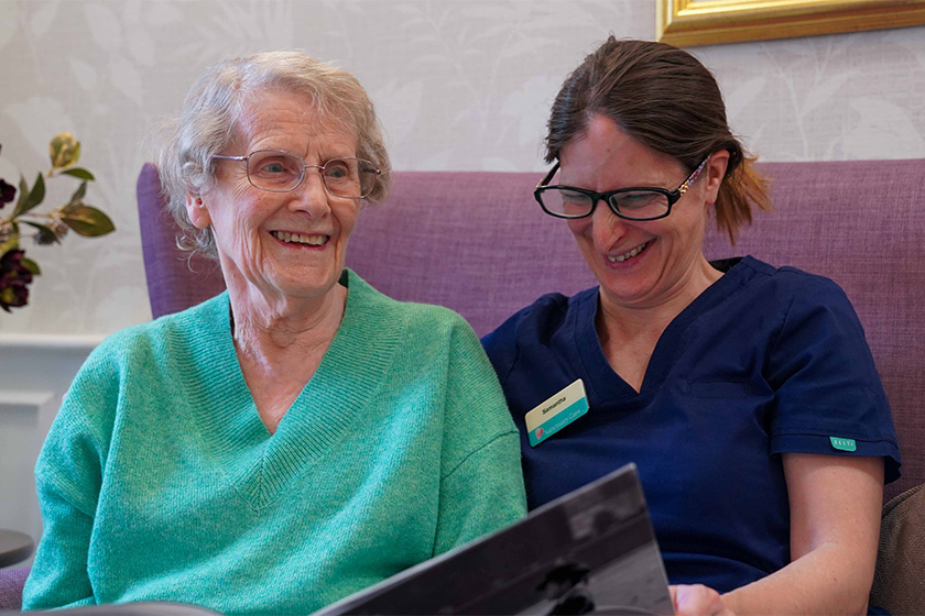 Photo of elderly lady with carer smiling