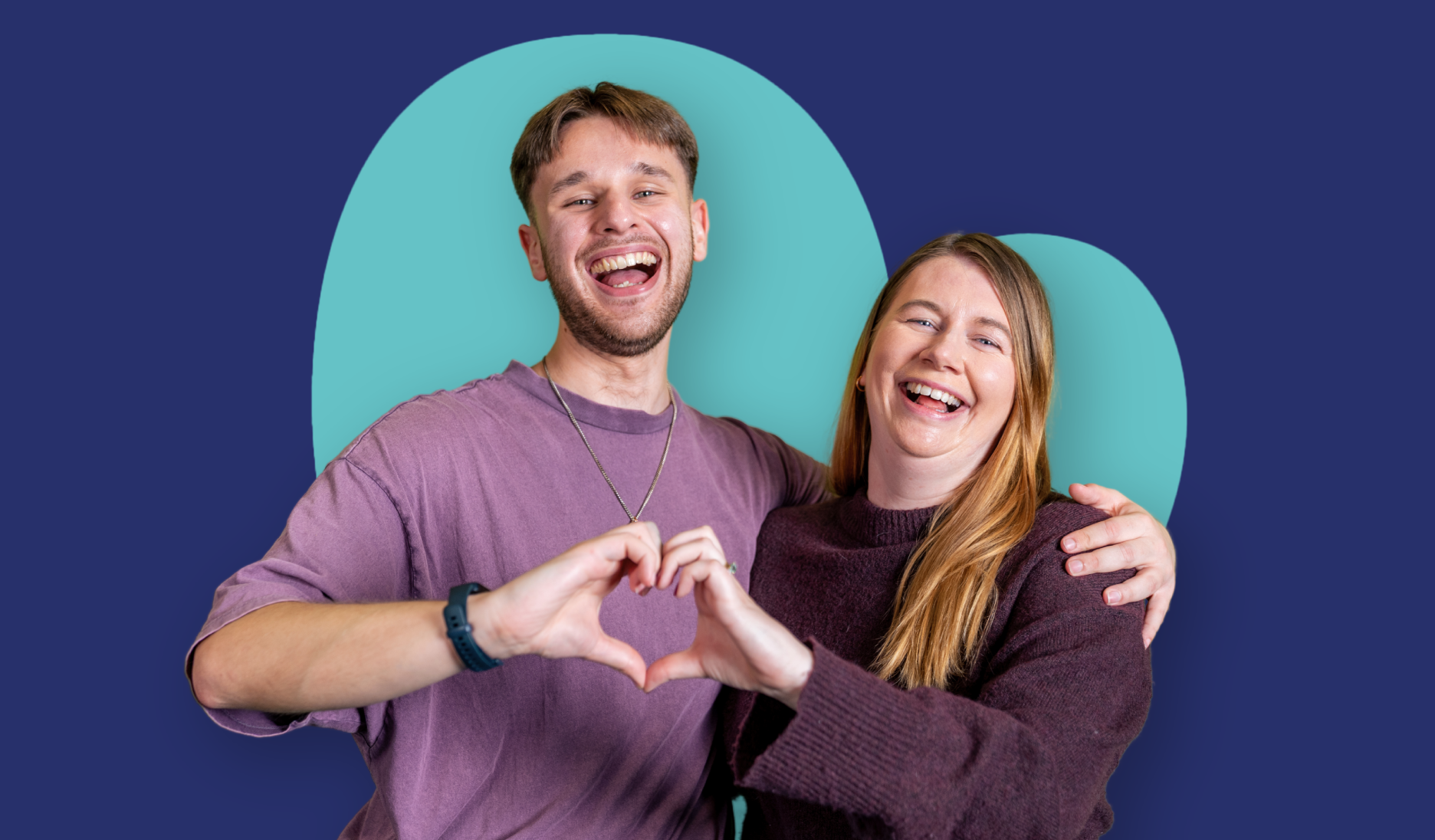 Two people standing side by side with their arms around each other, making a heart shape with their hands against a blue background with large heart shape