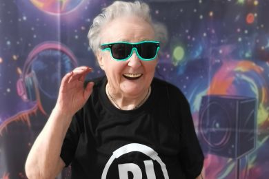 Resident smiling and dancing wearing sunglasses