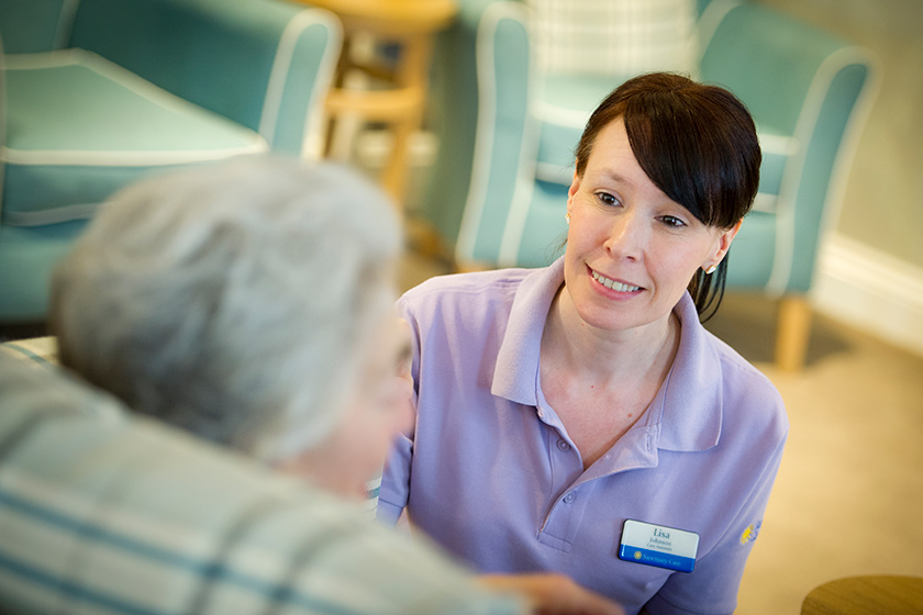 Sanctuary Care Assistant Lisa Johnson caring for a resident