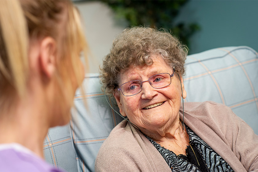 Resident smiling at Sanctuary Care staff member