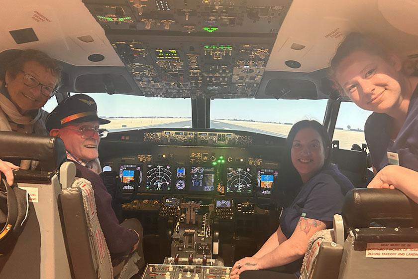 Ex aircraft engineer on cloud 9 after taking to the skies David Auld beams with joy as he enjoys a flight simulator experience with wife Jean and two staff from Queens Care Home in South Ayrshire