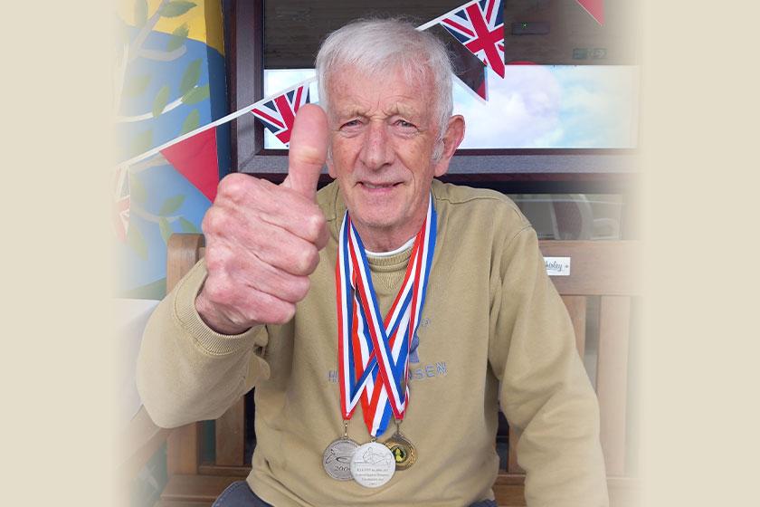 Keith is going for gold Keith, a care home resident at Trevarna in Cornwall, proudly displays his medals following the care home's own version of the summer games