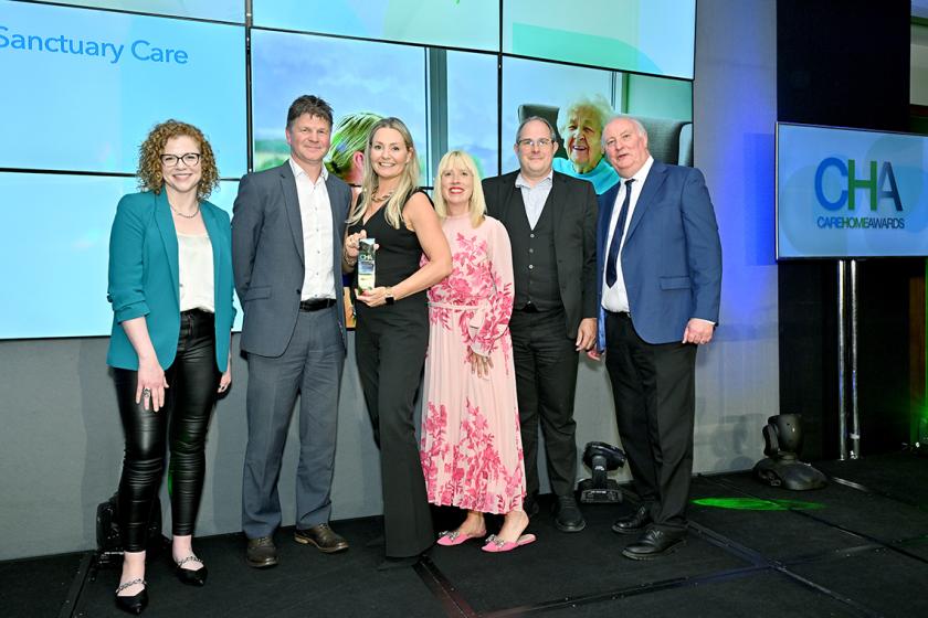 Award Winners for Sanctuary Care Group of professionals smiling holding award