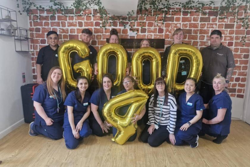 Forefaulds celebrate their Good CQC report A group of people smiling holding gold balloons that say 'Good 4'.