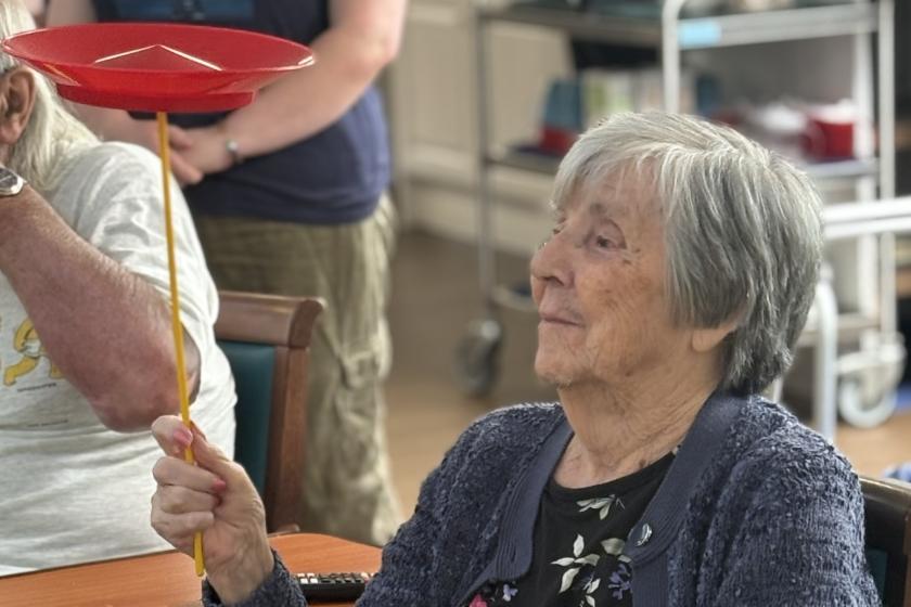 Care home resident Betty tries her hand at plate spinning