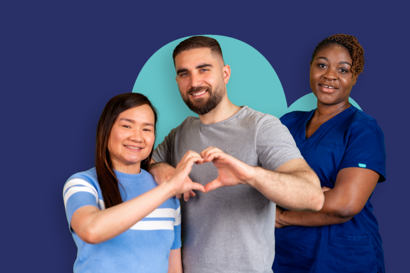 Three people standing in front of a dark blue background, two forming a heart shape with their hands. One wears a striped shirt, another a grey shirt, and the third a blue medical uniform. A light blue circular design is visible behind them.