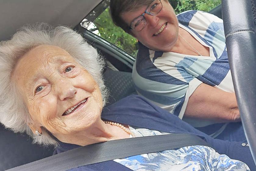 Cicely beams behind the wheel of the car with Karen, a driving instructor