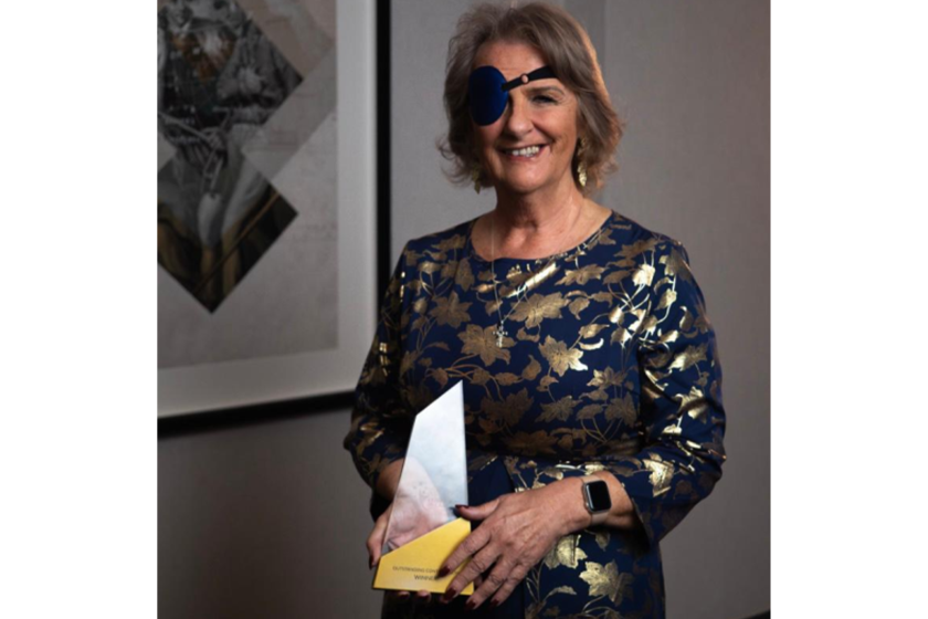 Sanctuary Care's Sheila O'Connor smiles for the camera holding her award