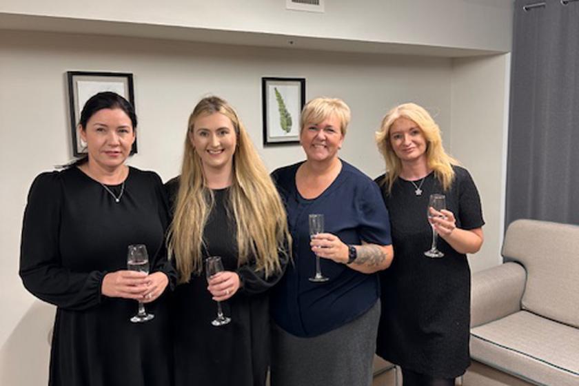 Staff stood together smiling