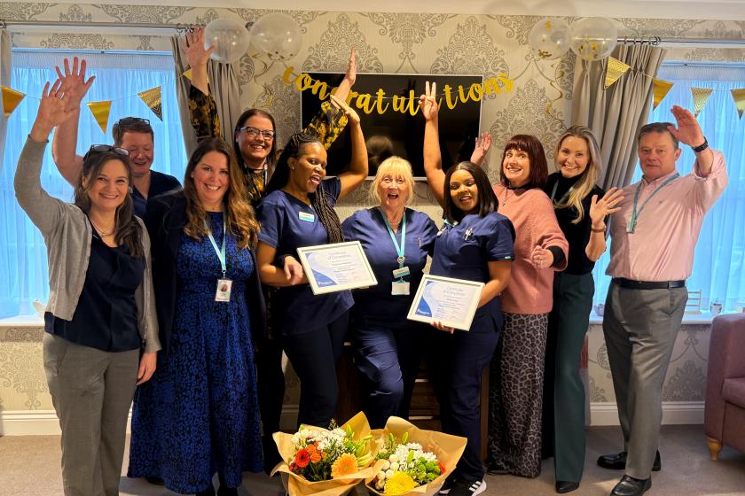 Staff stood together smiling