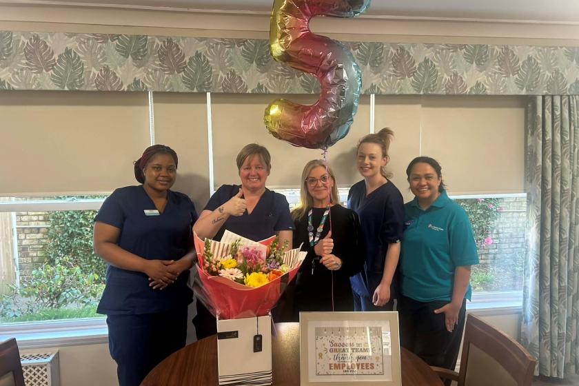 Staff stood together smiling