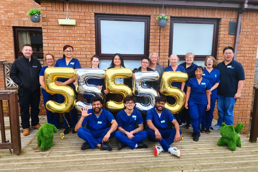 Staff stood together smiling