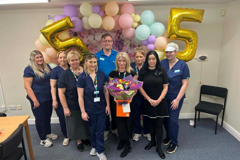 Staff smiling with balloons