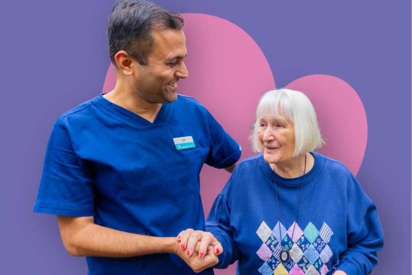 ID24 Jobs nursing careers - What makes us different Two people in blue nursing uniforms laughing together against a pink and blue gradient background.