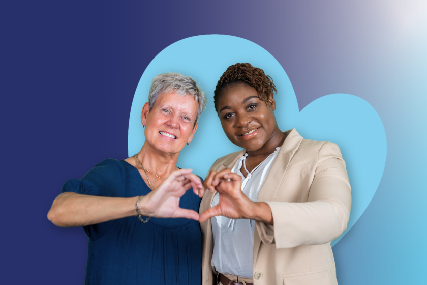 ID51 Jobs our people stories - Bannerv2 Two people standing together with their hands forming a heart shape, in front of a large heart shape on a blue gradient background.