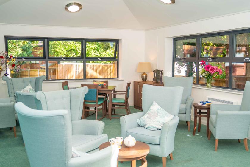 A large room featuring an arrangement of various chairs and tables, suitable for group activities or events.