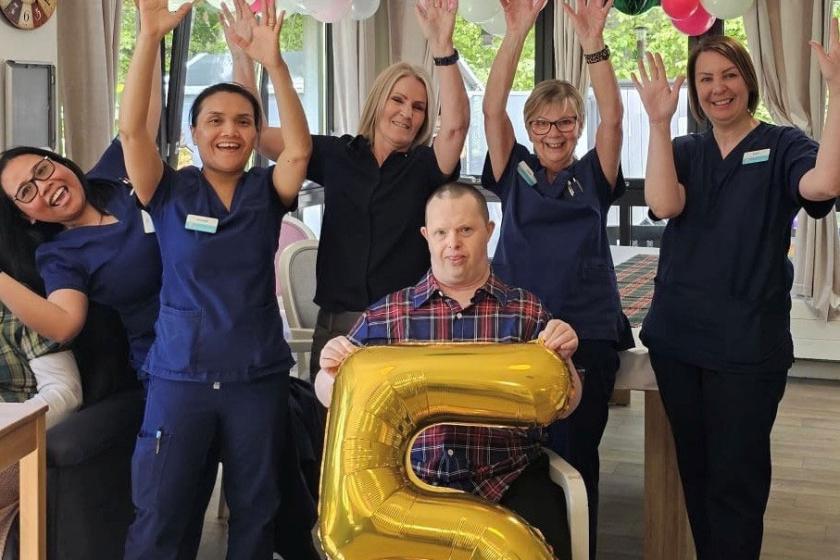 Staff stood together smiling