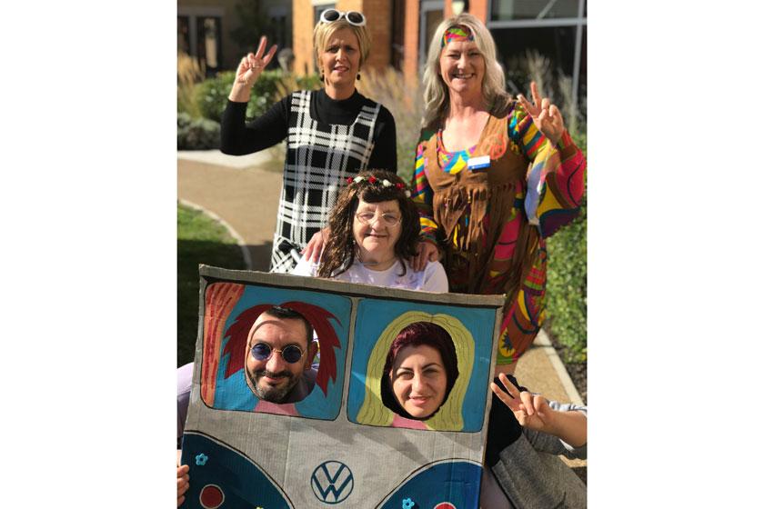 Staff and residents dressed up in swinging sixties fancy dress.