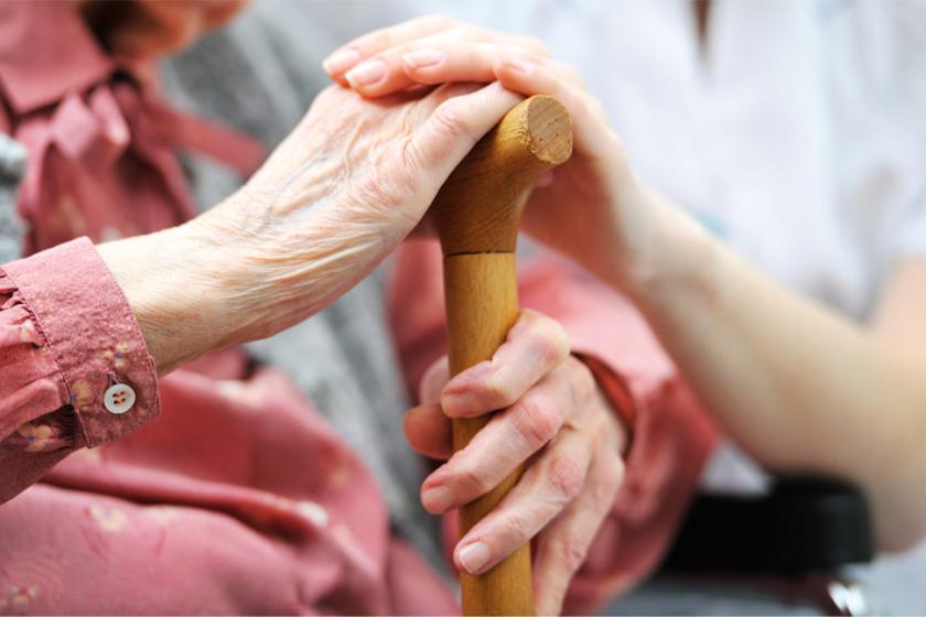 Elderly woman being comforted