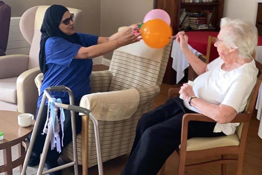Mary taking part in the light exercise with balloons