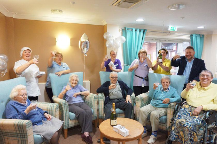 Staff and residents celebrating at Ravenhurst Residential Care Home