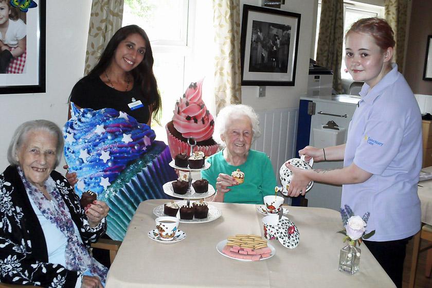 Residents, a volunteer and the Lime Tree care assistant with cupcakes and tea.