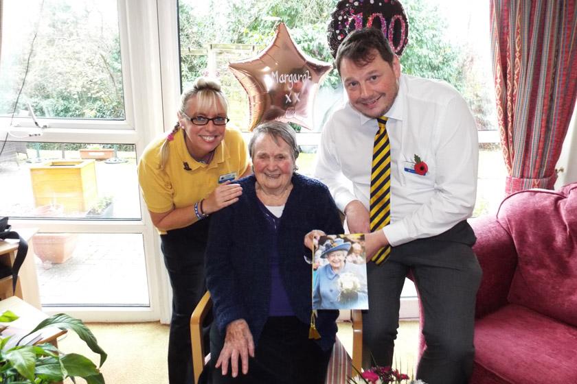 Margaret celebrating her 100th birthday with Sanctuary Care staff members.
