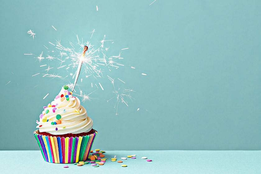 Birthday cup cake topped with a sparkler