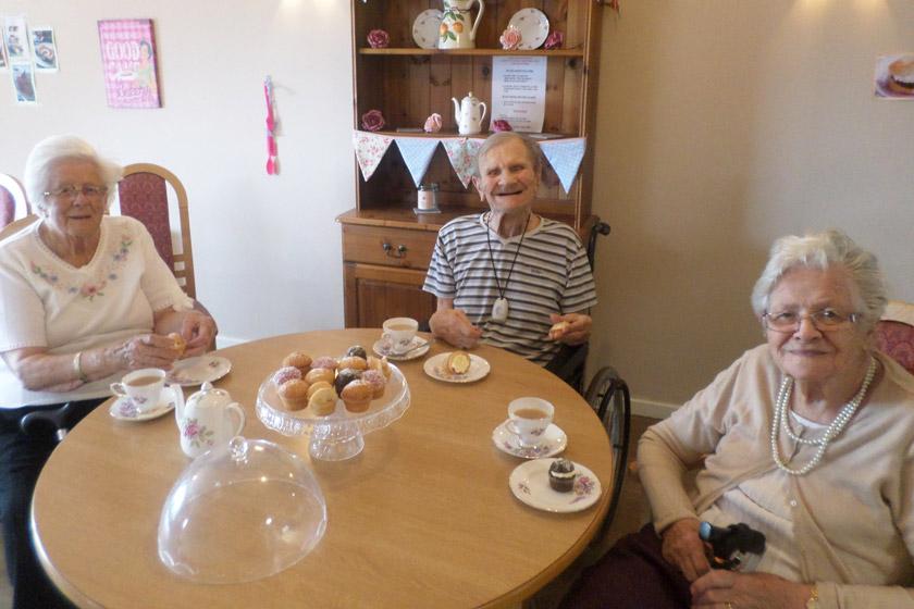 Residents with some of the homemade cakes