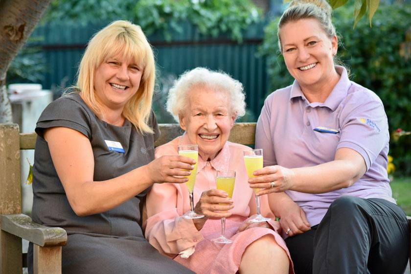 Staff and a resident celebrating at Heathlands Residential Care Home in Pershore.