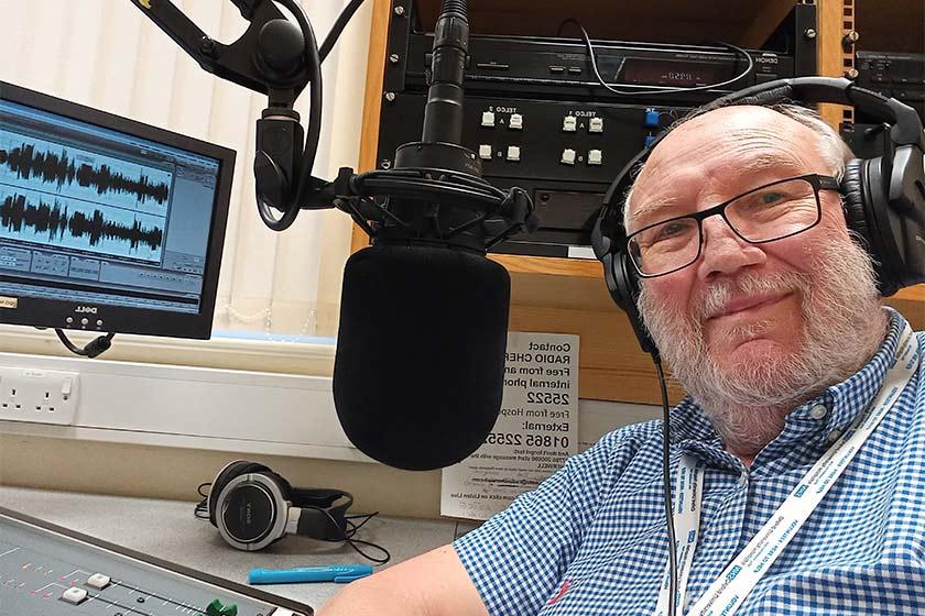 John Lant sitting in the studio wearing a headset