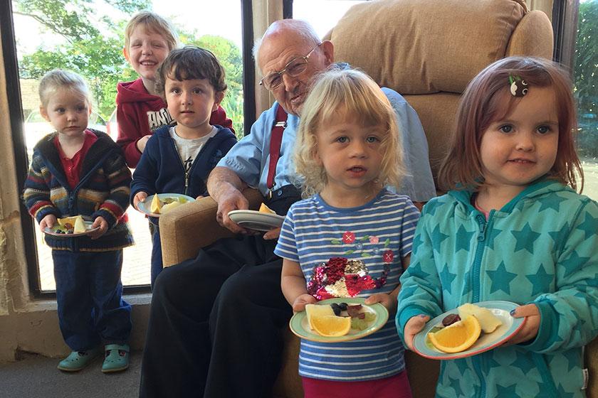 Children with resident George and their fruit.