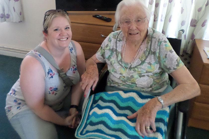 Sylvia and Emma with the crochet blanket made by Emma.