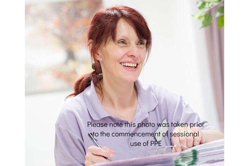 Sanctuary care staff member with a PPE disclaimer