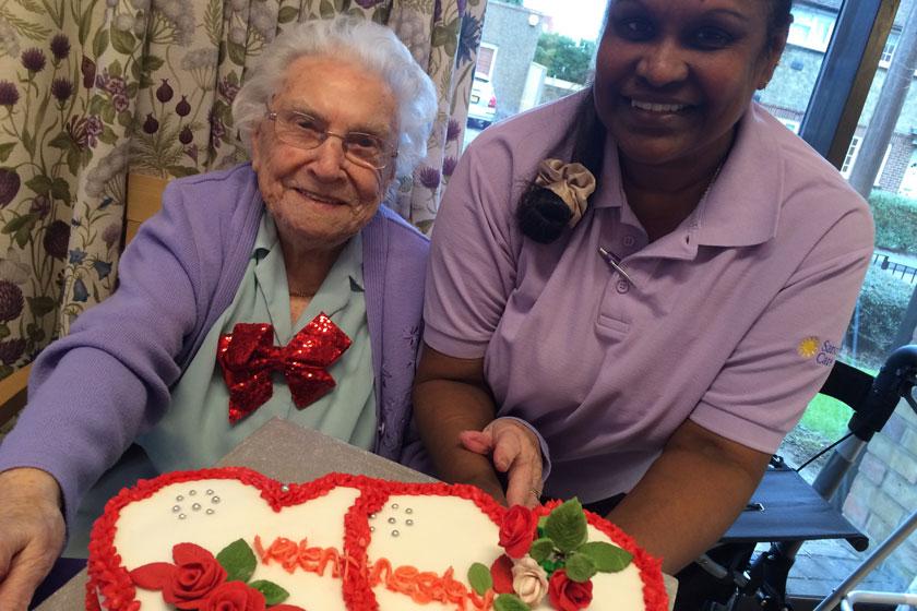 102-year-old resident Lucy Savage and staff member Udaya Manikkalatnam.