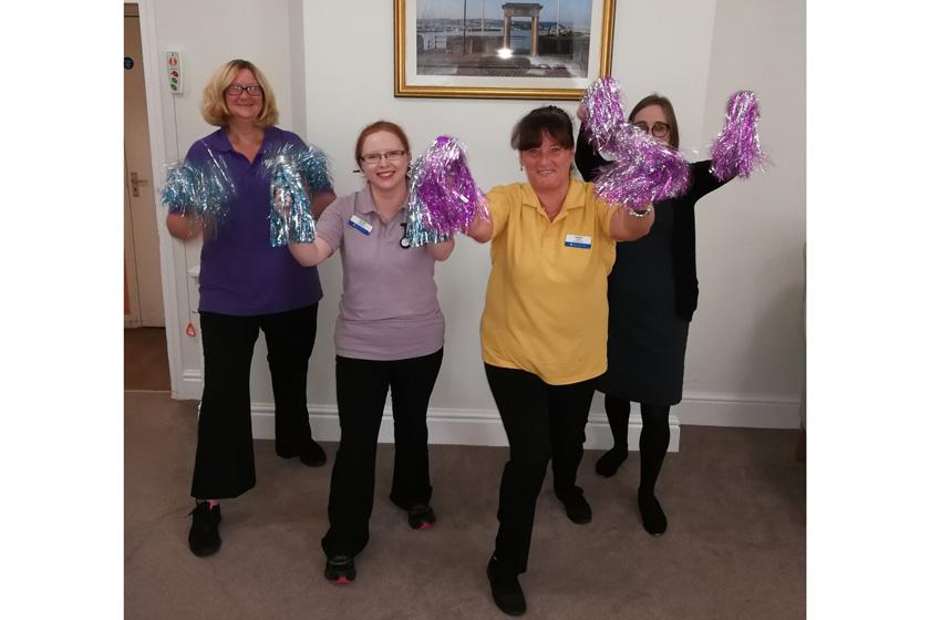 The team at Furzehatt with their pom poms for armchair aerobics.