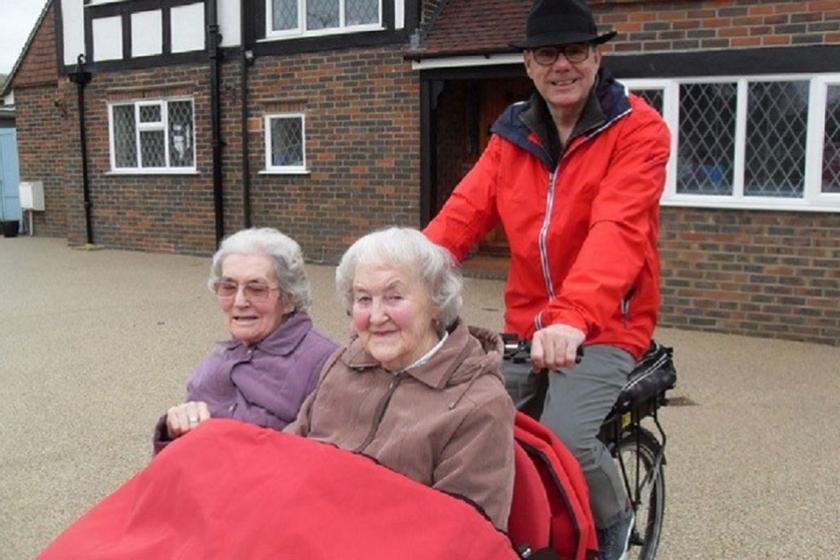 Care home residents being taken for a spin on a trishaw bike
