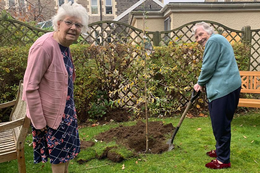 June and Pat plant a tree at Beach Lawns Residential and Nursing Home in Weston-super-Mare 