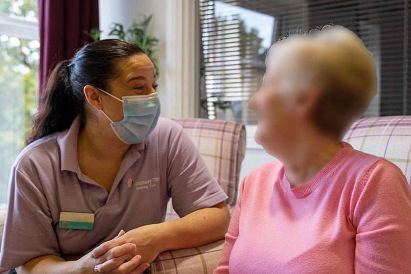 A care assistant chats with a resident