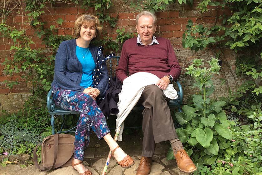 Alison Adcock and her late father Michael Atkinson sitting on a garden bench at Heathlands Residential Care Home