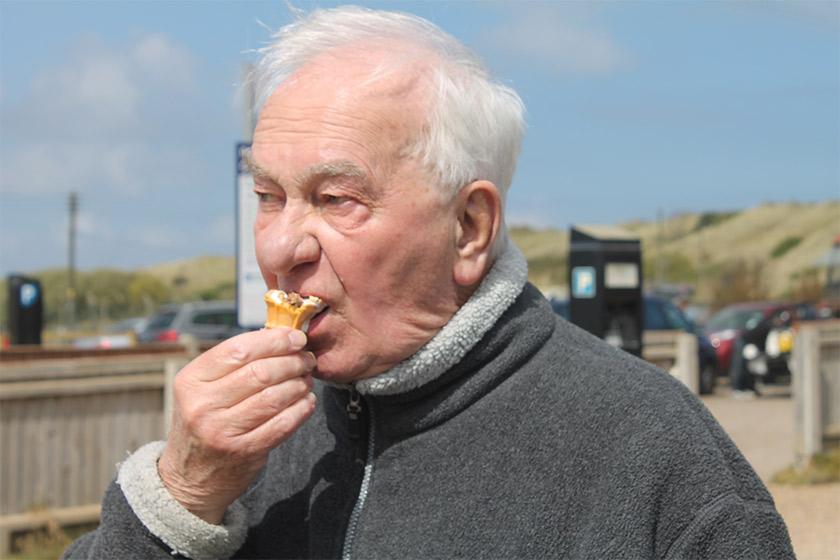 Sanctuary Care resident Ken Andrews eating an ice cream at the beach