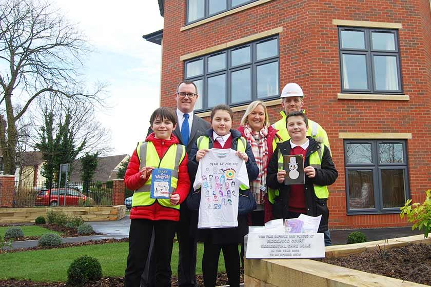 Children visit a Sanctuary Care home in Pensby. left to right (front) are: Michael Joynes, Amy Chambers and Luke Leyland with left to right (back) home manager Simon Doherty, Teaching assistant Win Brett and senior site manager Anthony Thompson.