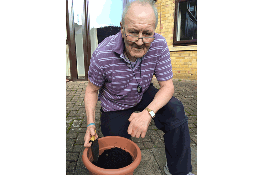 Resident, Geoffrey Leer, gets ready to grow fresh vegetables with the gardening club.