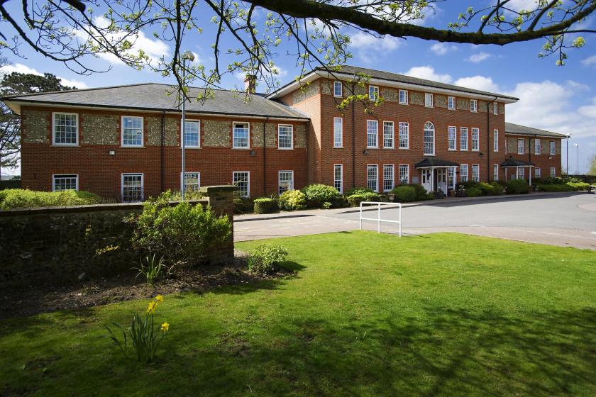 Watlington and District Nursing Home Watlington care home entrance with a greenery area in front of it.