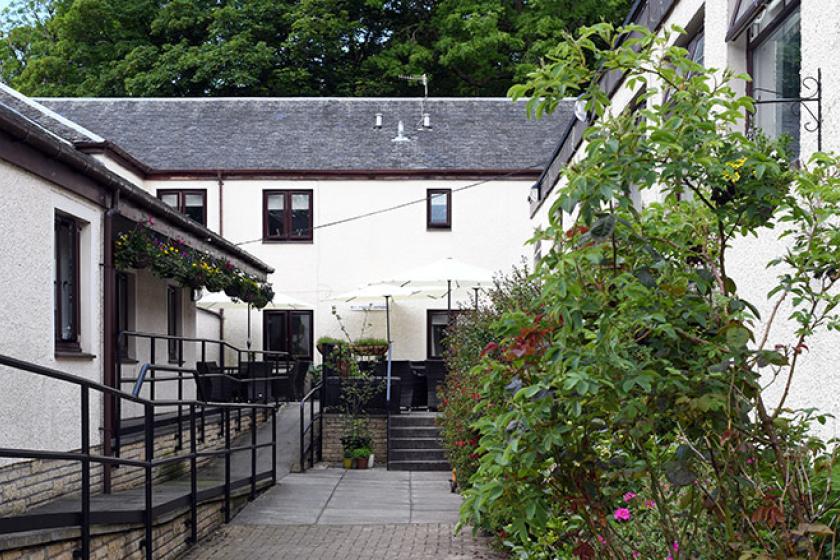 Entrance of Millport care home with a surrounding garden area.