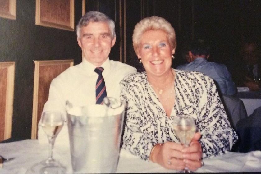 A photograph of a happy couple enjoying a glass of wine with each other